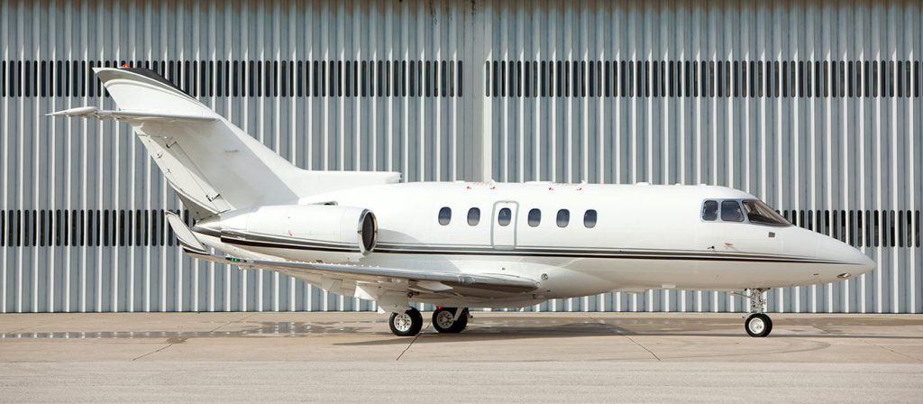 Aircraft parked in front of hangar
