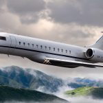 Private jet flying over mountains